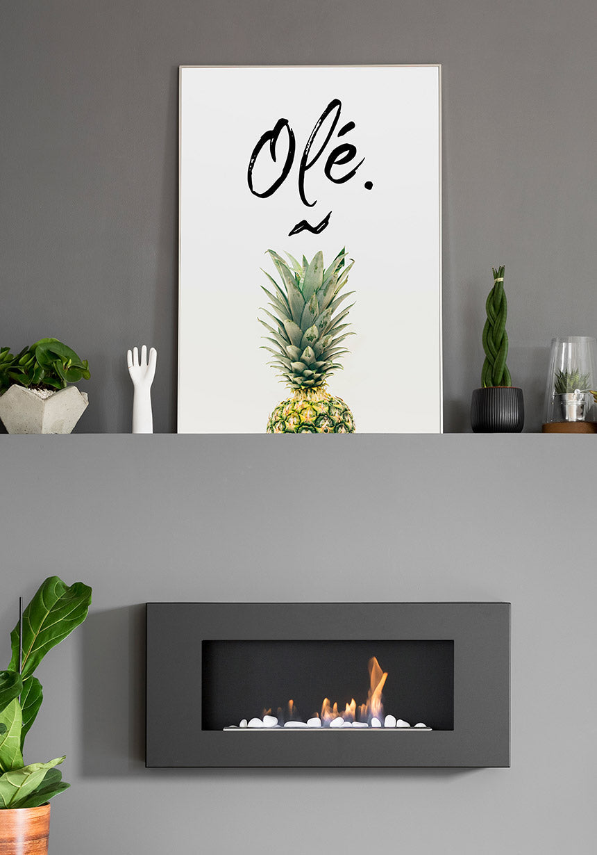 Pineapple poster with Olé typography about fireplace in the living room
