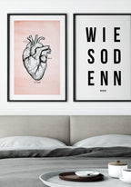 Poster with heart illustration on pastel red background above bed