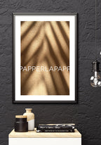Poster on sand with shadow over sideboard