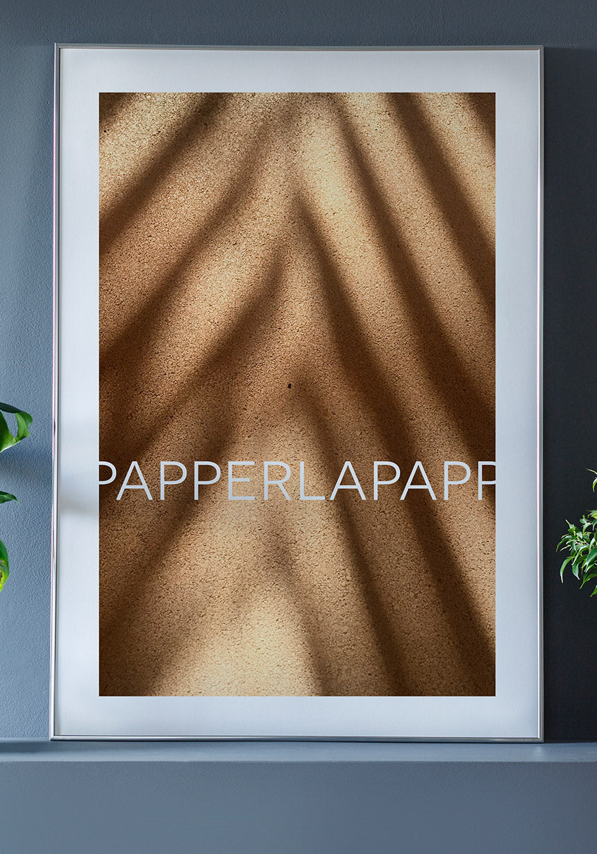 Poster on sand with shadow in frame