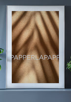 Poster on sand with shadow in frame