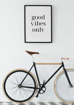 black-white good vibes only poster on bicycle